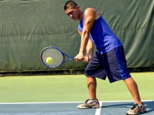 young-man-was-playing-a-game-of-tennis-on-the-court-725x544